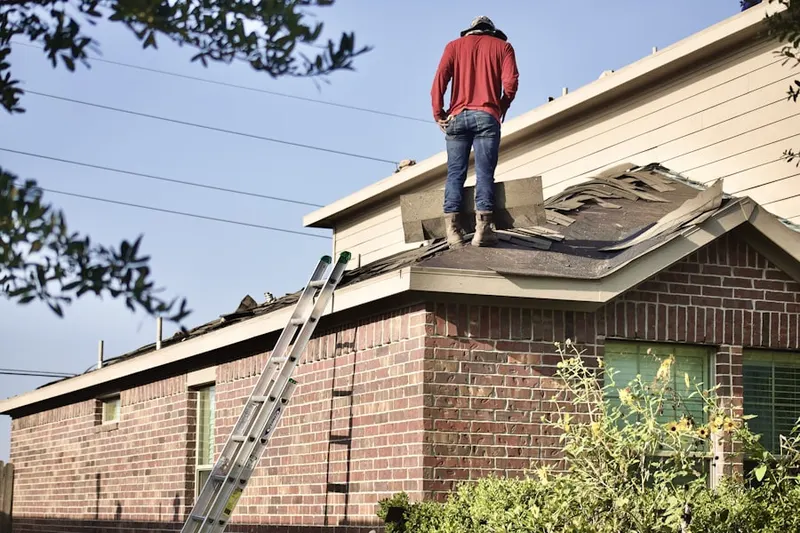Professional roofer working on a residential roof in Wimbledon Estates